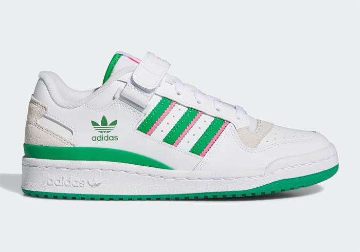 Side view of white, green, and pink adidas shoes.